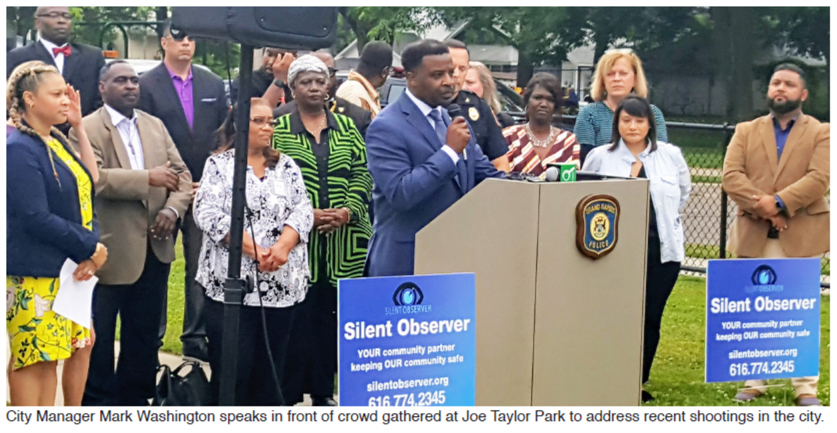 City Manager Mark Washington speaks in front of crowd gathered at Joe Taylor Park to address recent shootings in the city.